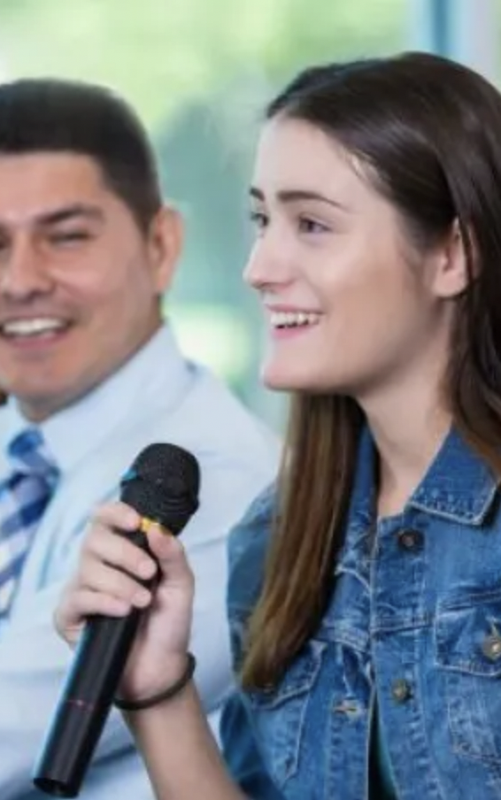 woman holds microphone