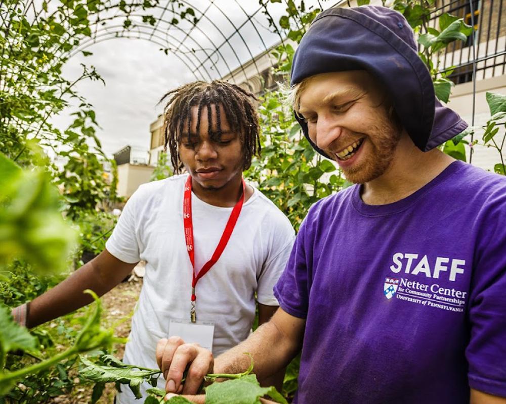 Teacher and student work in greenhouse