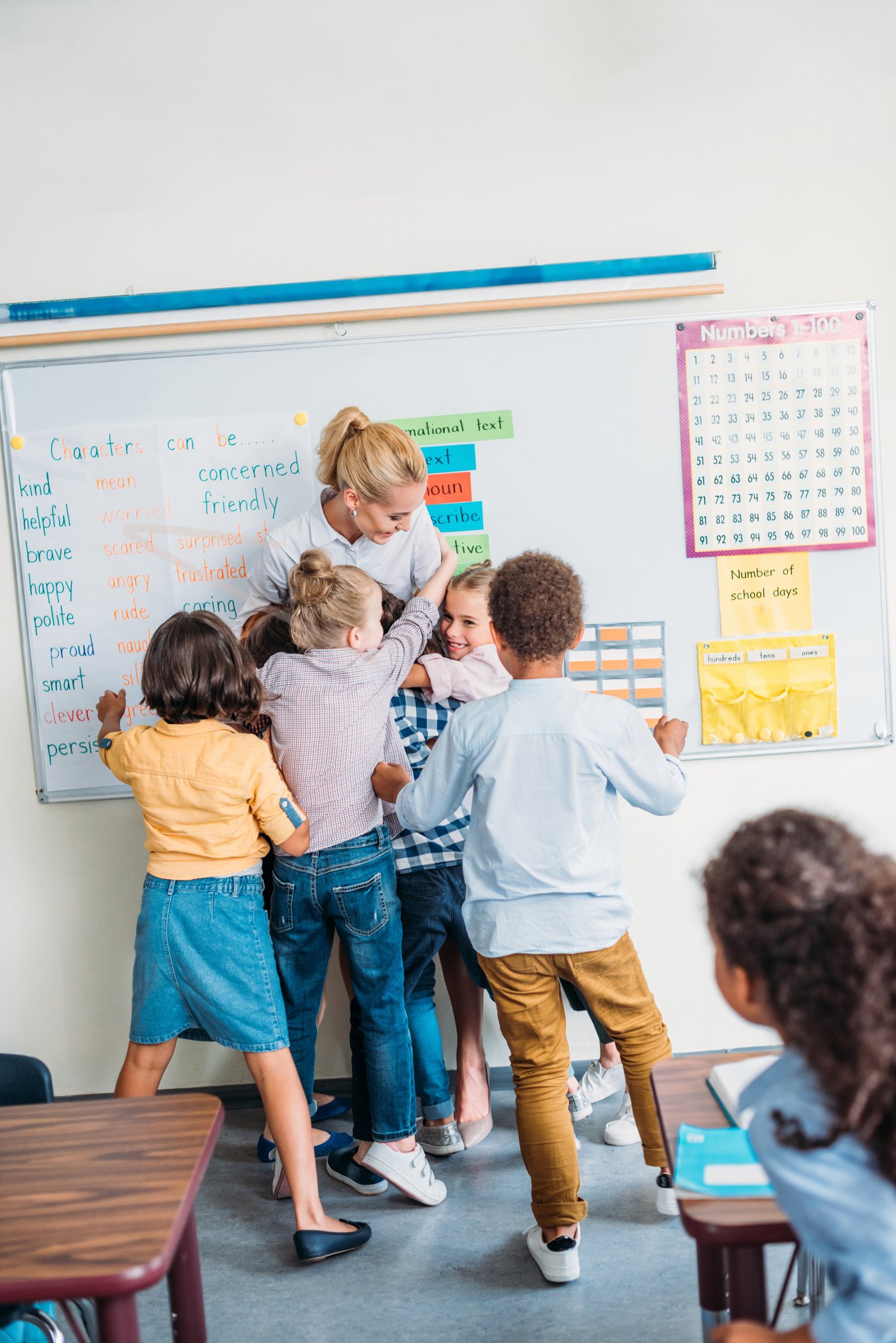 students hug teacher
