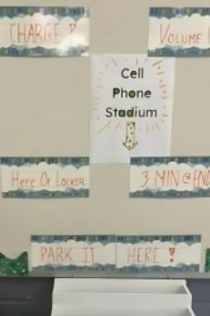 "Classroom cell phone storage area labeled 'Cell Phone Stadium' with various instructions for students."