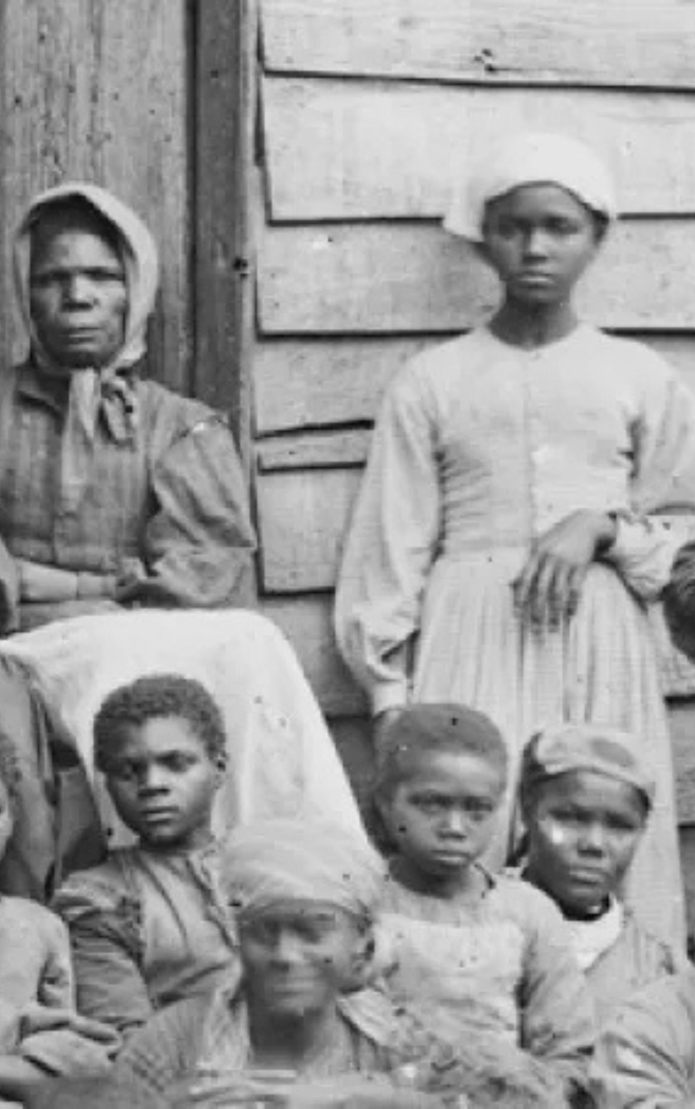 Historic photograph of enslaved African American women and children in the American South, taken near the time of the Civil War, illustrating the human impact of slavery and the significance of the Emancipation Proclamation and battles like Antietam in the fight for freedom.